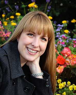 Adult patient with braces smiling outdoors