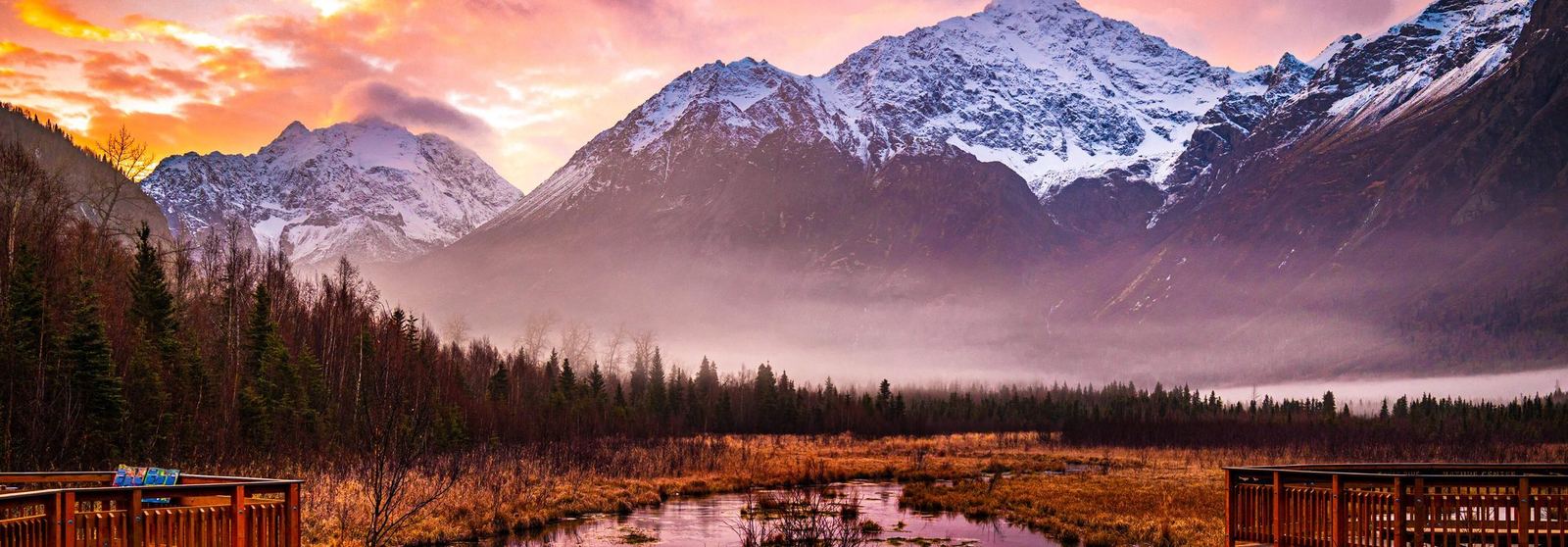 Sunrise over snow-covered Alaska mountains and wetlands near Eagle River